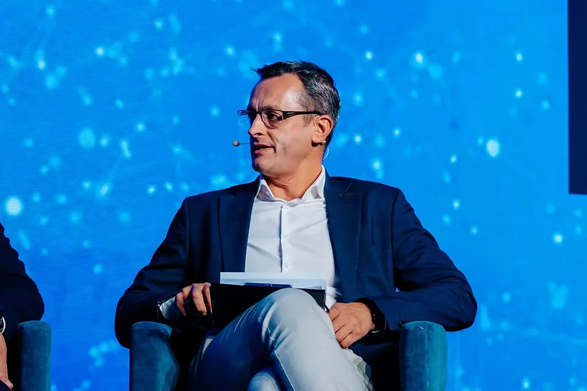 Alexander Morari seated on stage with his notes, listening to a panellist during PropTech Connect Europe 2026 in London.