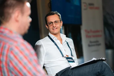 Alexander Morari with a headset microphone in a fireside conversation at Engaged Investments 2023 in Prague.
