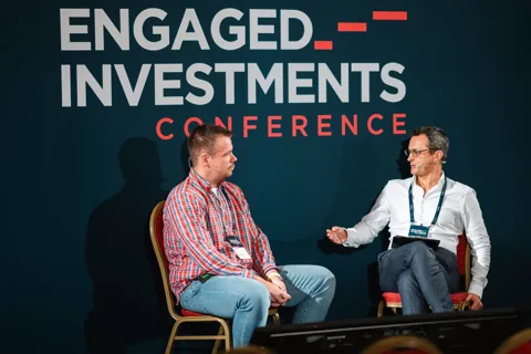 Alexander Morari in conversation in front of the Engaged Investments logo in Prague, 2023.
