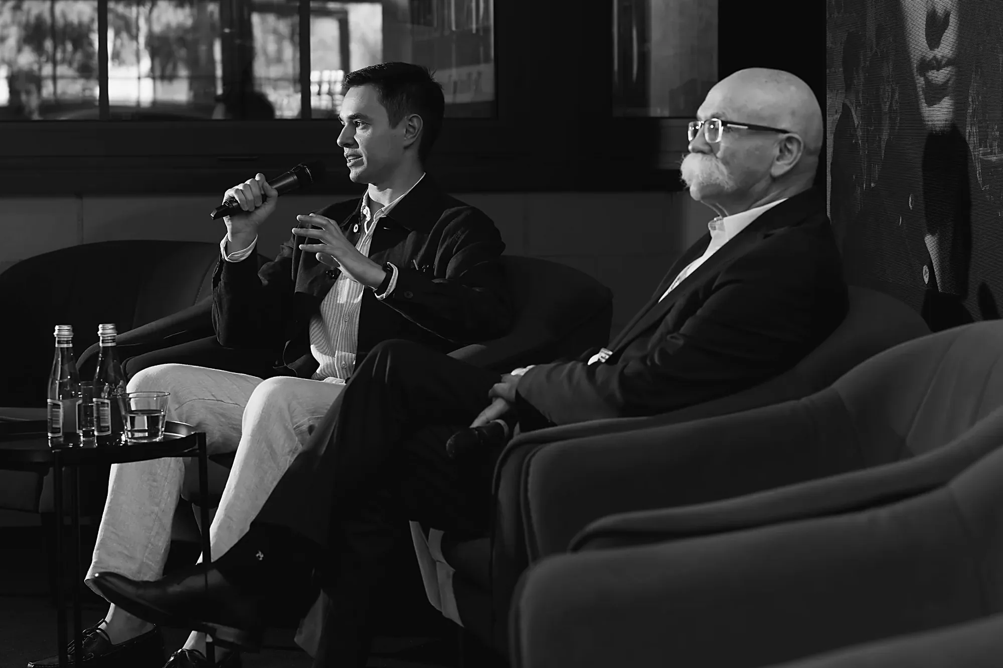 Two speakers mid-conversation during the fireside chat at Mid-Summer Night 2026 in Warsaw