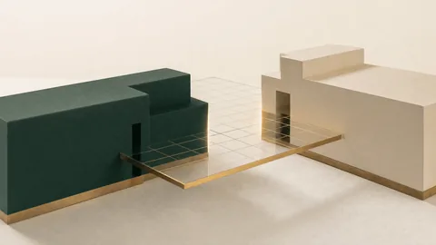 Conceptual illustration: a dark green block and an off-white block edging towards each other across a thin glass grid, a line of gold light where they almost align.